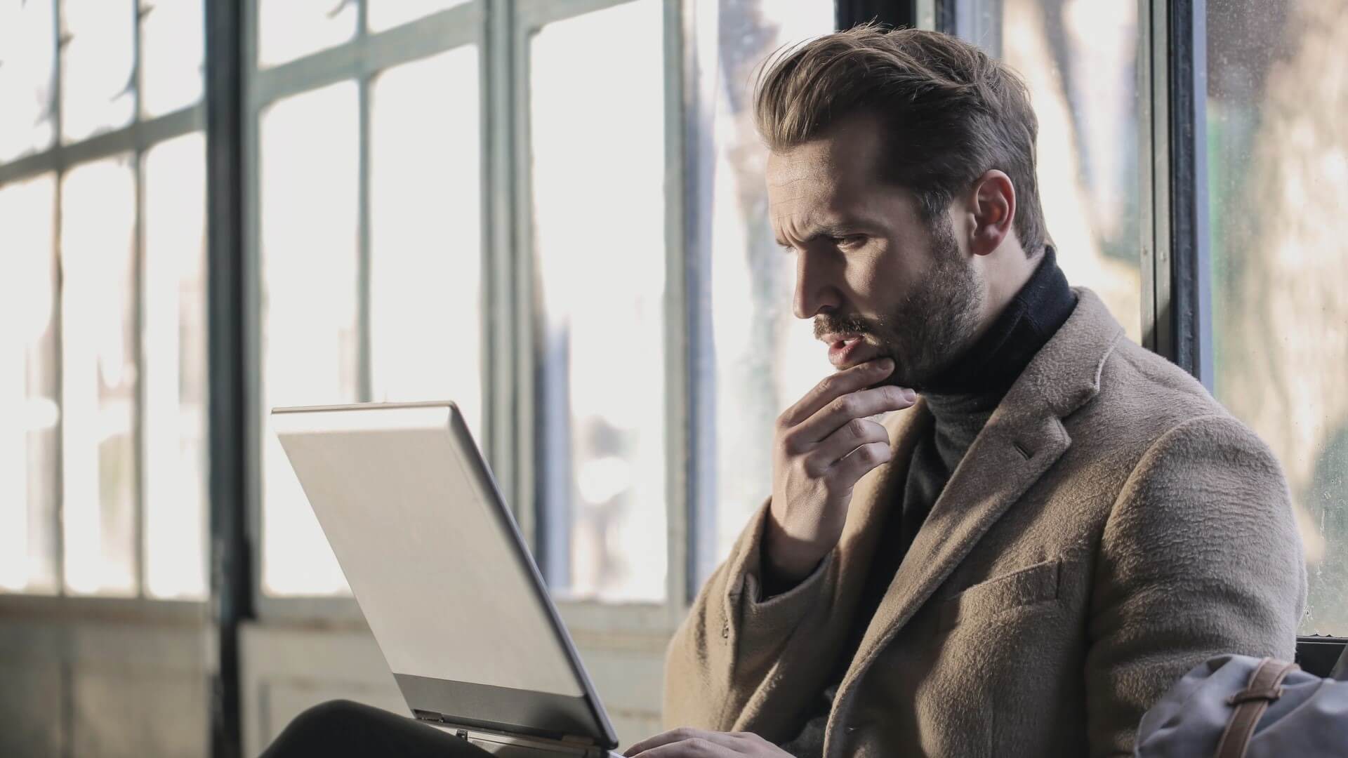A-Man-Working-on-a-Laptop-1920x1080 أفضل 3 طرق لتعطيل التحكم في حساب المستخدم على Windows 11