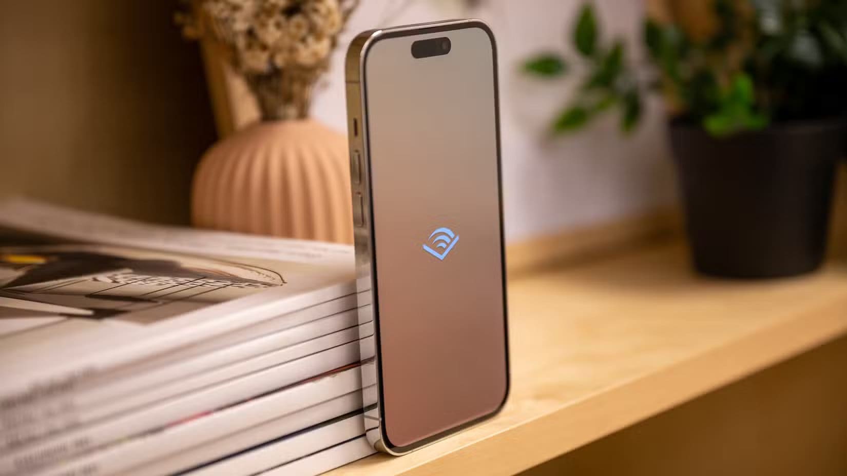 Left-side-of-the-Apple-iPhone-14-Pro-with-the-Audible-logo-on-the-screen أشياء يجب ألا تفعلها على جهاز Mac مطلقًا