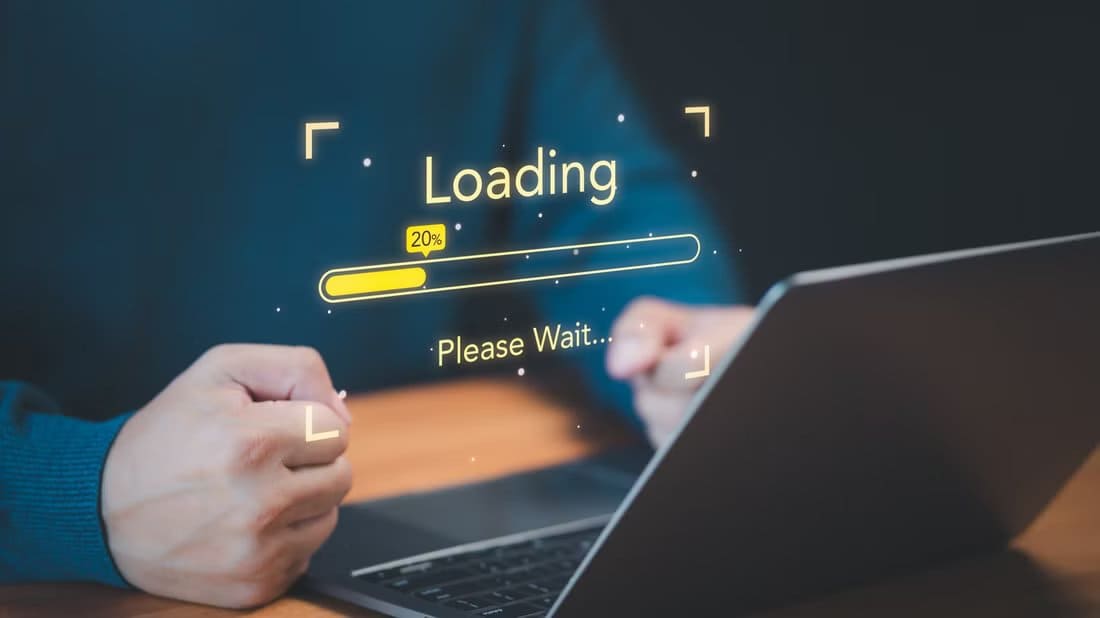 a-person-using-a-laptop-with-fists-clinched-in-frustrating-and-a-loading-progress-bar-floating-above-the-laptop السبب الرئيسي لبطء مواقع الويب وكيفية إصلاحه بدون أدوات مدفوعة