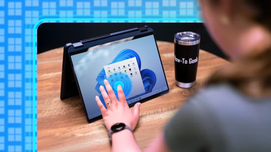 person-using-the-touch-screen-on-a-windows-11-laptop أفضل برامج ويندوز المجانية التي تحول الكمبيوتر إلى أداة أكثر قوة وسلاسة