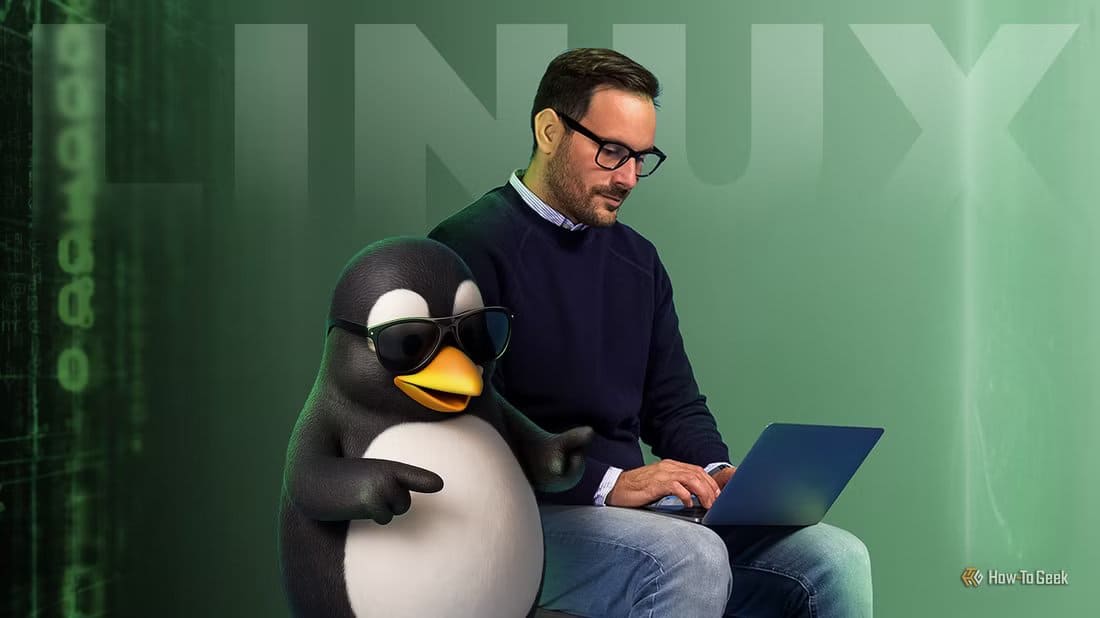 a-man-using-a-laptop-next-to-tux-the-linux-mascot-wearing-sunglasses علامات تثبت أنك أصبحت مستخدمًا متقدمًا في Linux