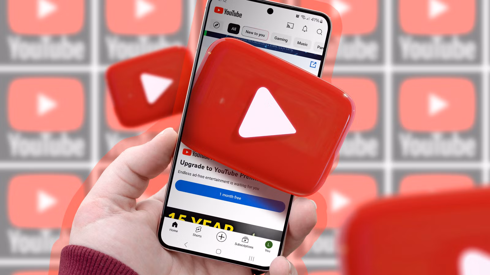 a-hand-holding-a-phone-with-youtube-logo-coming-out-of-the-screen-and-several-youtube-logos-in-the-background كيفية تحسين تجربة تصفح YouTube بتغيير إعداد واحد فقط