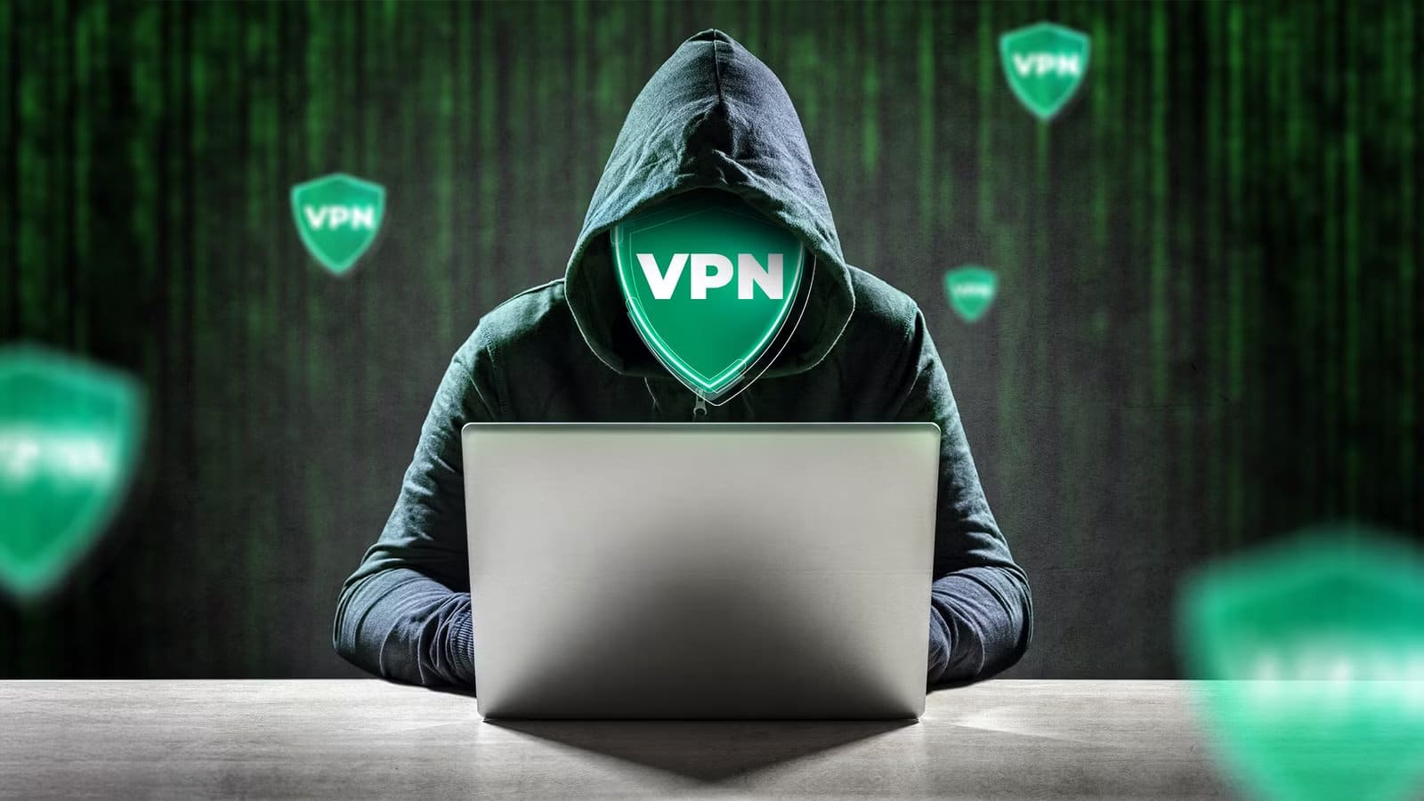 a-hooded-person-using-a-laptop-with-a-glowing-green-vpn-shield-for-a-face-and-multiple-vpn-shields-floating-in-the-background هل تمنحك شبكات VPN الخصوصية الكاملة التي تعتقد أنك تملكها