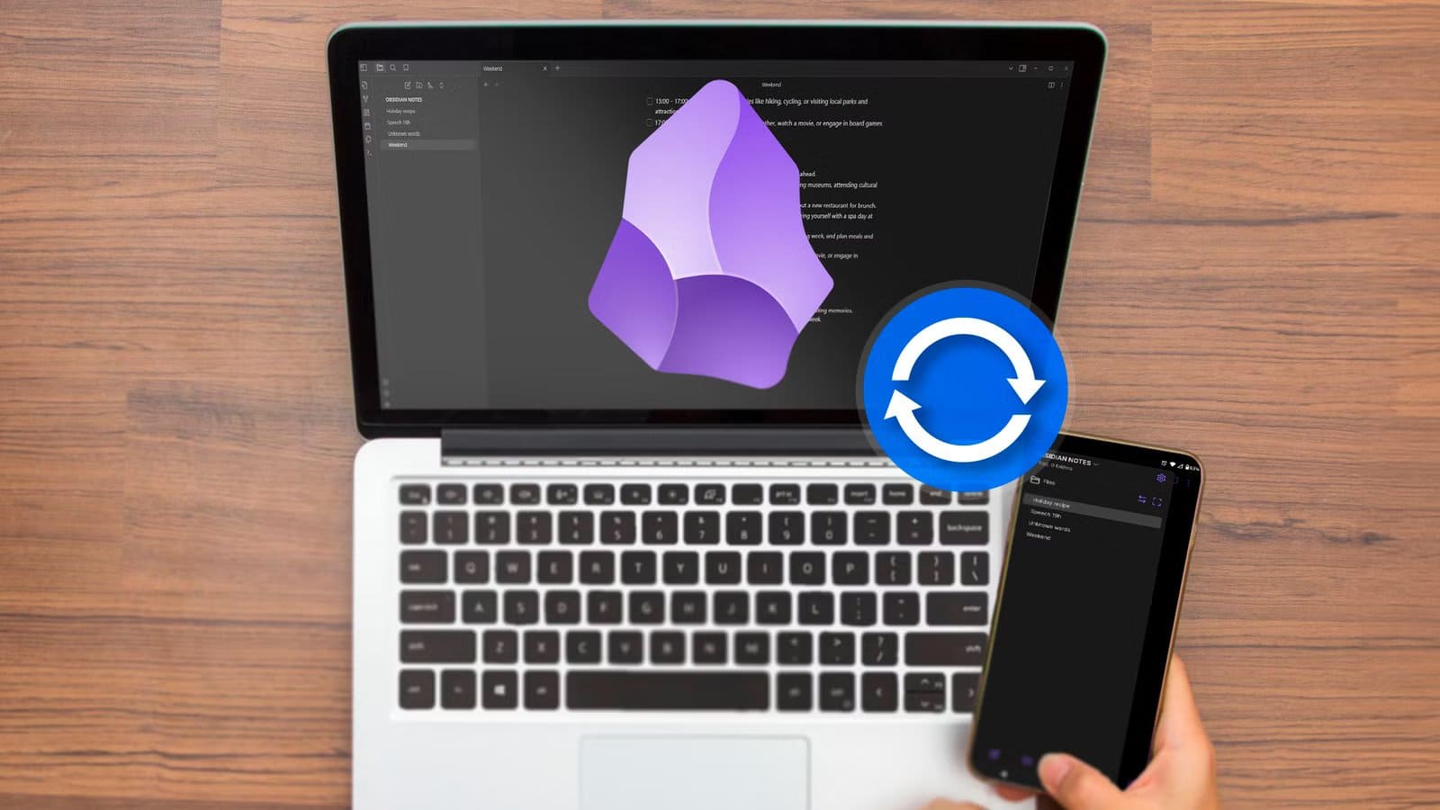 a-laptop-and-a-smartphone-with-obsidian-open-the-obsidian-logo-in-the-center-of-the-laptop-screen-and-a-sync-icon أفضل بديل لتنظيم ملاحظات Obsidian باستخدام مدير ملفات خارجي أكثر مرونة