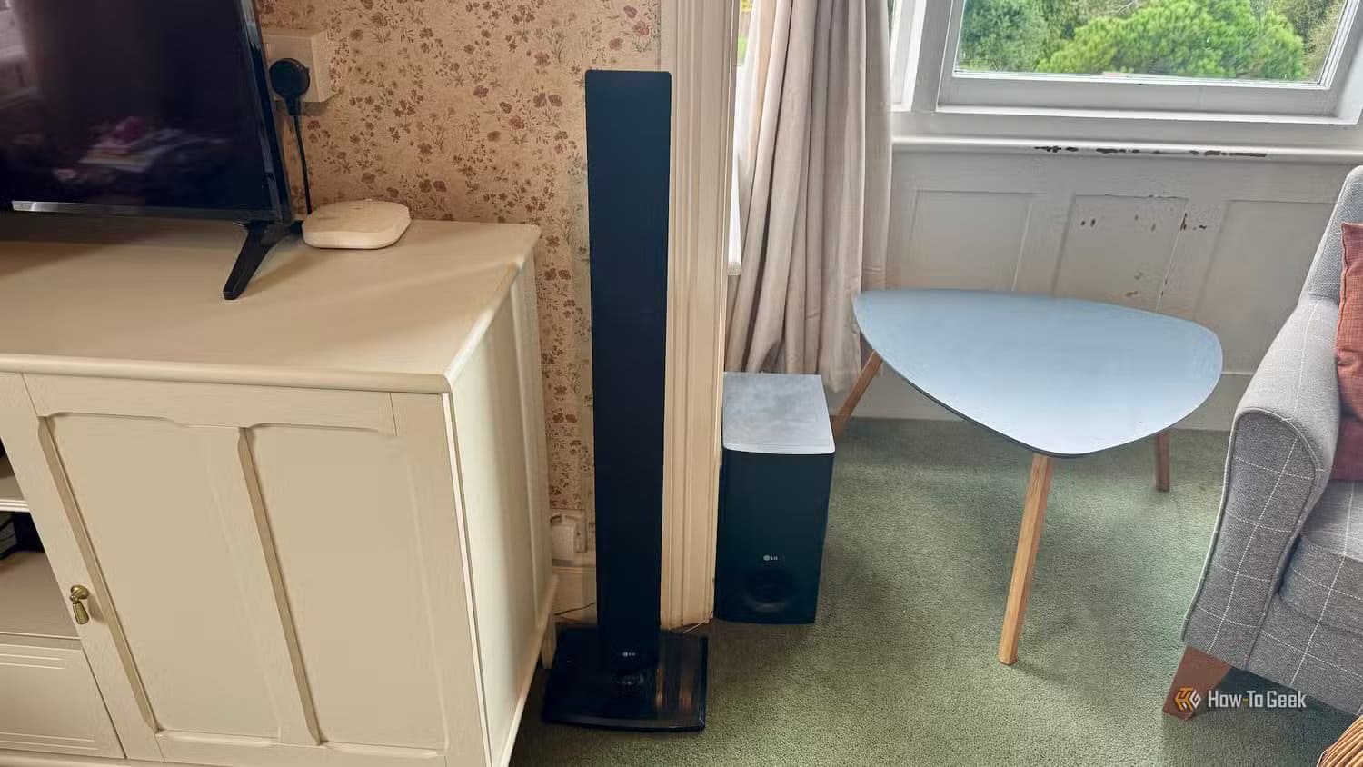 a-floor-standing-front-speaker-and-a-subwoofer-for-a-surround-sound-sytem-in-a-living-room_ 3 طرق فعالة لتحسين أداء التلفزيون الذكي القديم واستعادة سرعته