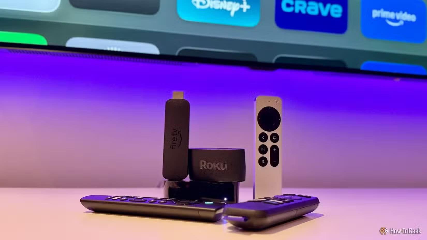 an-apple-tv-4k-fire-tv-stick-and-a-roku-streaming-device-with-their-remotes 3 طرق فعالة لتحسين أداء التلفزيون الذكي القديم واستعادة سرعته