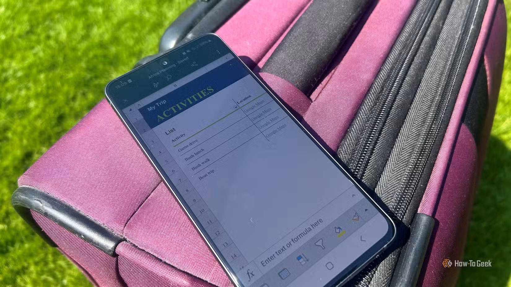 a-smartphone-displaying-the-excel-mobile-app-with-a-travel-workbook-open-resting-on-a-suitcase-outdoors كيف تنشئ وضع الإجازة على هاتف سامسونج جالاكسي بنقرة واحدة