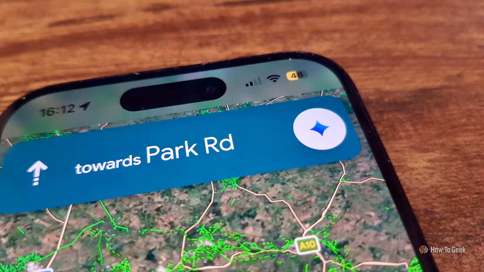 the-gemini-button-in-google-maps-on-a-phone 5 تطبيقات تعمل مع خرائط جوجل لتسهيل التنقل والسفر